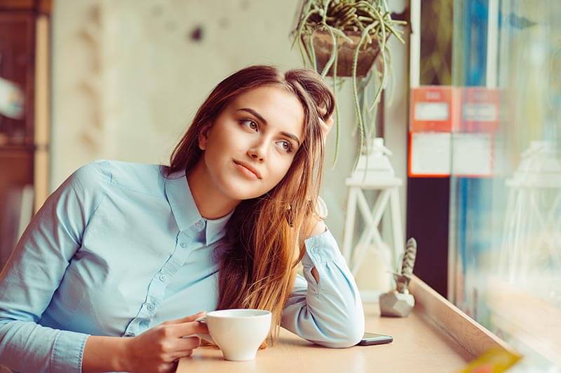 Woman Thinking While Drinking Coffee
